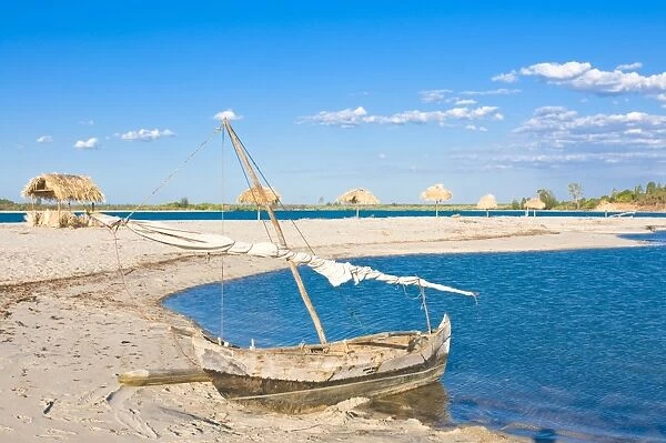 Outrigger boat lying on bank of sand, Antsanitian Beach Resort, Mahajanga, Madagascar, Indian Ocean