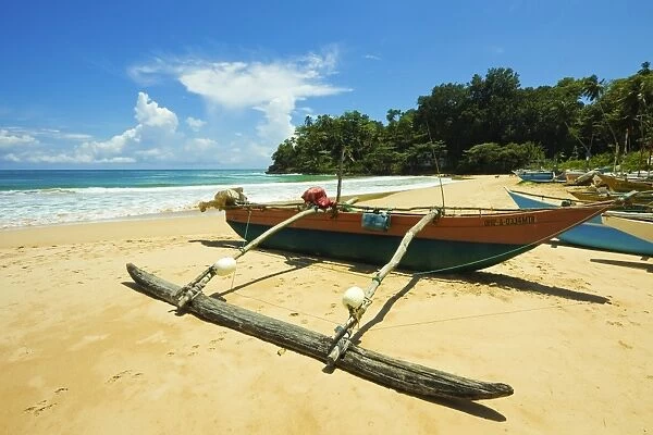 Outrigger fishing boat at this quiet south coast retreat beach, Talalla, near Matara, Southern Province, Sri Lanka, Asia