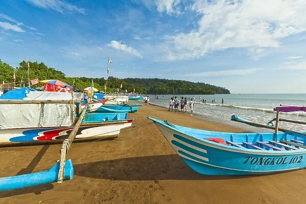Outrigger fishing boats on west beach of the isthmus at this major beach resort on the south coast, Pangandaran, Java, Indonesia, Southeast Asia, Asia