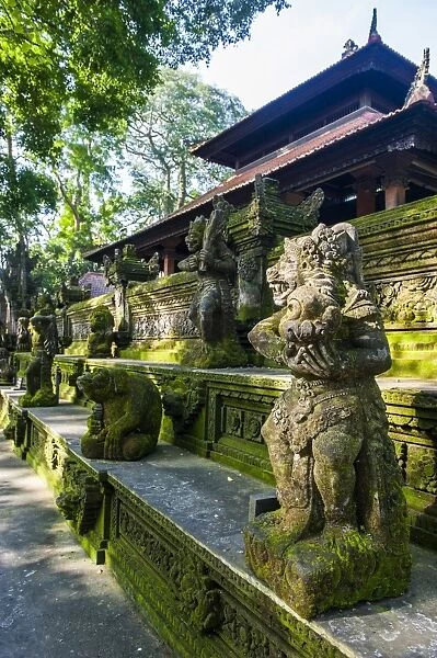 Overgrown statues in a temple in the Monkey Forest, Ubud, Bali, Indonesia, Southeast Asia, Asia
