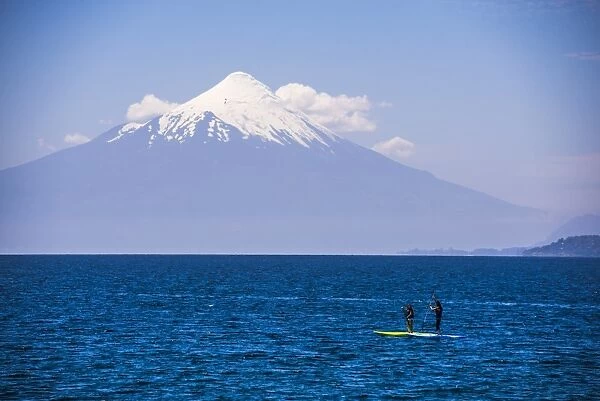 Paddleboarding on Llanquihue Lake with Osorno Volcano (Volcan Osorno) behind, Puerto Varas