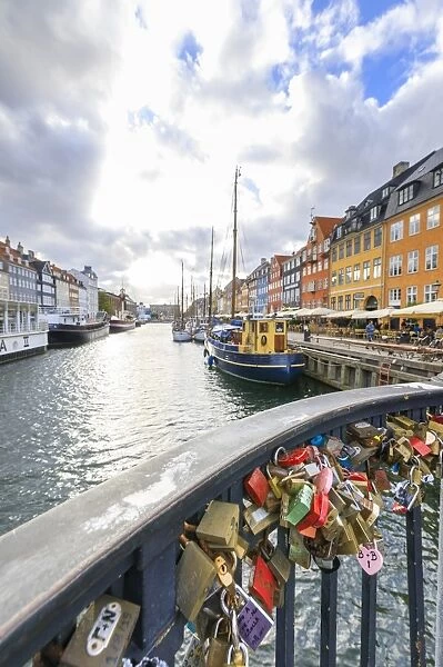 Padlocks on a terrace along the typical canal and harbour of the district of Nyhavn