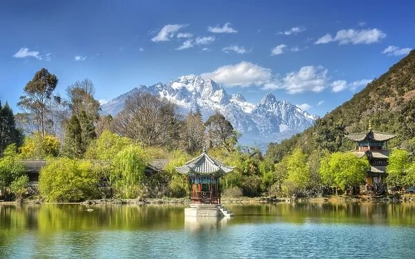 Pagodas with Yu Long Xue Shan (Jade Dragon Snow Mountain) in Jade Spring Park in spring, Lijiang, Yunnan, China, Asia