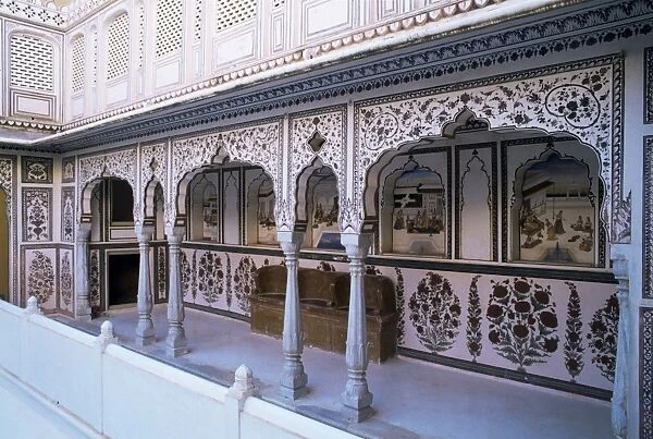 The painted walls of a covered verandah which surrounds