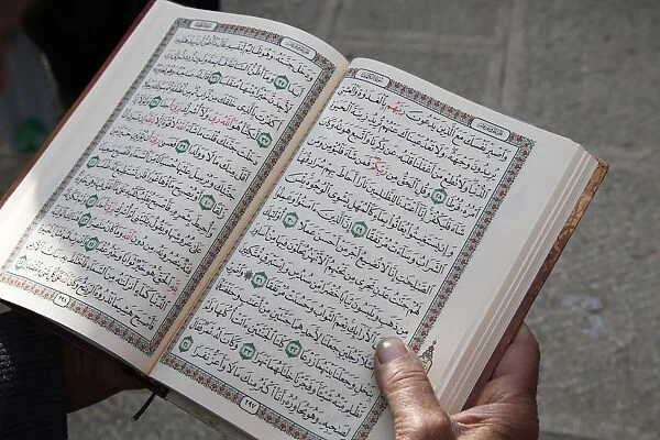 Palestinian reading the Koran outside Al-Aqsa mosque, Jerusalem, Israel, Middle East