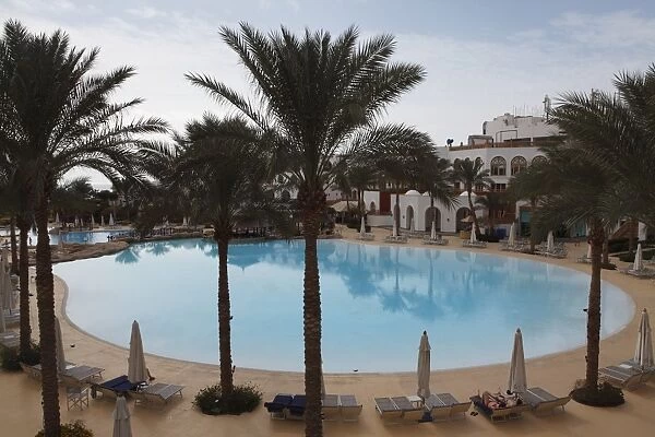 A palm fringed swimming pool within the Royal Savoy Resort at Sharm el-Sheikh