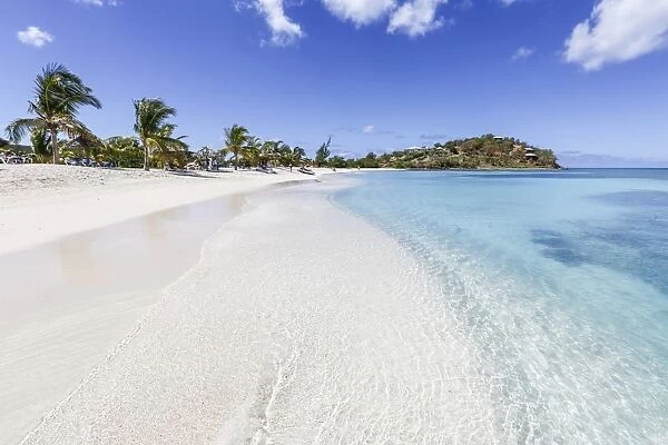 Palm trees and white sand surround the turquoise Caribbean sea, Ffryes Beach, Antigua