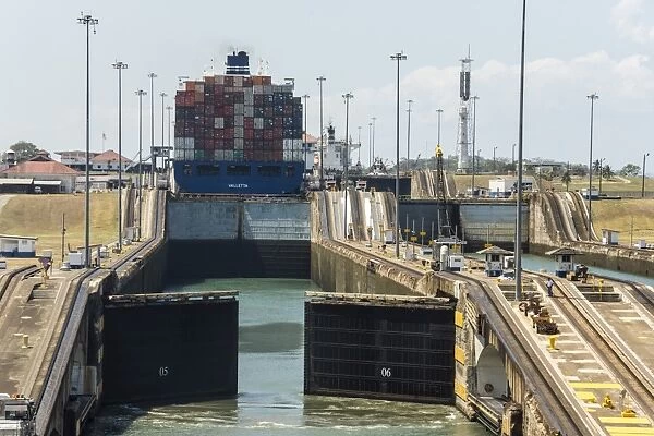 Panamax-sized container ship goiing up through Gatun Locks on Panama Canal, Panama