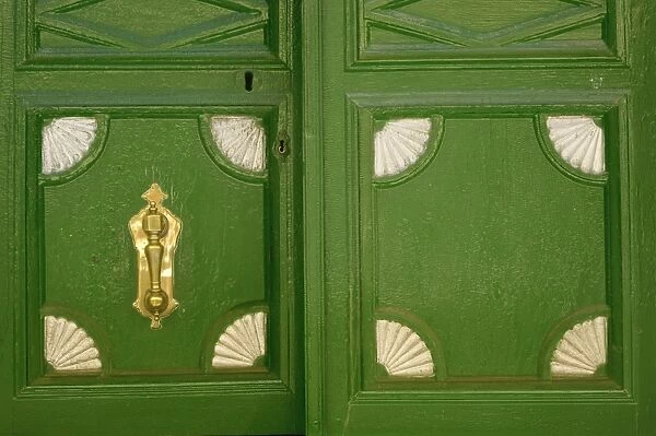 Detail of panels in a door with knocker at Piedrahita