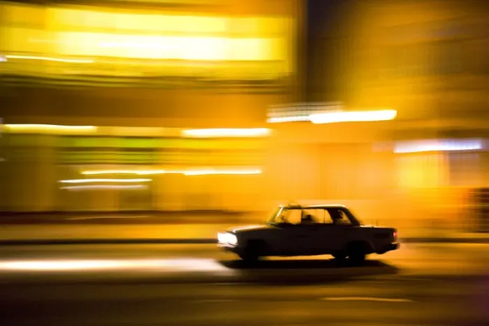 Framed Print : Panned shot of car at night passing illuminated buildings on The Malecon Framed Print : Panned shot of car at night passing illuminated buildings on The Malecon