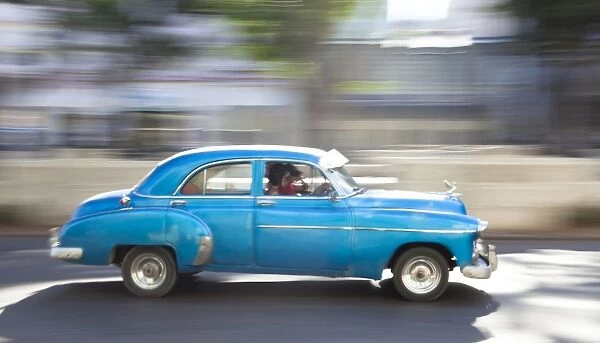 Panned shot of old American car to capture sense of movement, Prado, Havana Centro, Cuba, West Indies, Central America