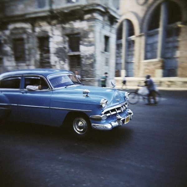 Panned shot of an old blue American car, Havana, Cuba, West Indies, Central America