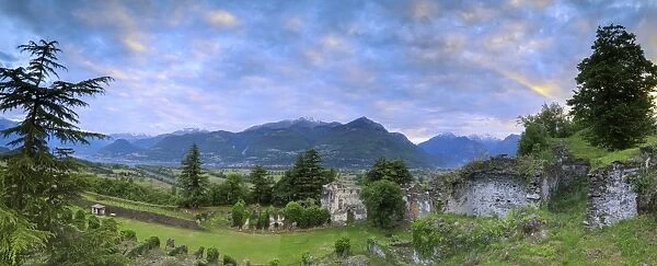 Panorama of ancient ruins of Fort Fuentes framed by green hills at dawn, Colico, Lecco province
