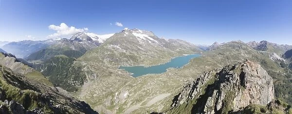 Panorama of the blue Lago Bianco surrounded by high peaks, Bernina Pass, Canton of Graubunden