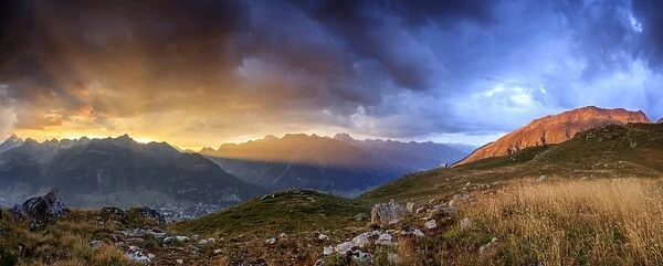 Panorama of the fiery sky on high peaks of Muottas Muragl at sunset, St