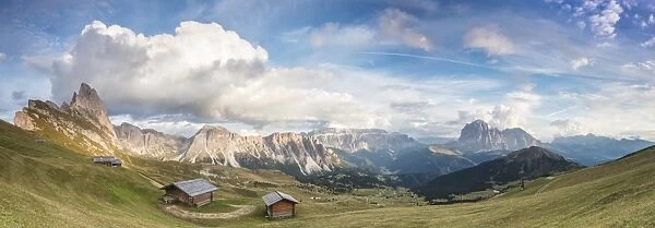 Panorama of green meadows and huts of the Odle mountain range seen from Seceda, Val Gardena
