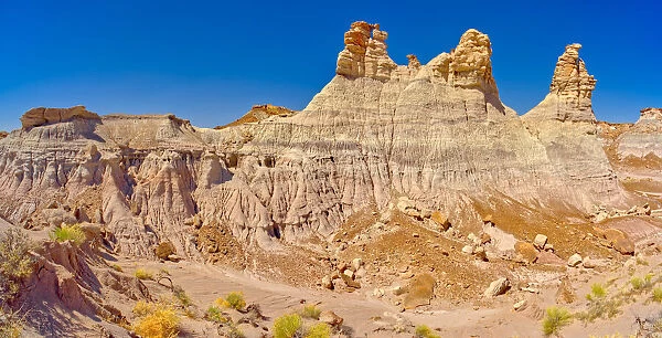 Panorama of three hoodoos shaped like kings, on the edge of the Blue Mesa in Petrified