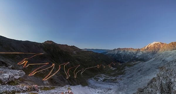 Panorama of lights of car trace at dusk, Stelvio Pass, Valtellina, Lombardy, Trentino Alto Adige