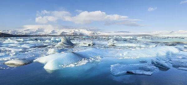 Panorama of mountains and icebergs locked in the frozen water, Jokulsarlon Iceberg Lagoon