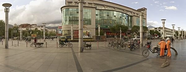Panorama showing the Potala Palace in the distance and a department store on a modern high street