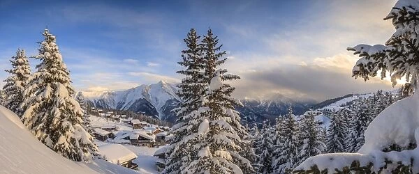 Panorama of snowy woods and mountain huts framed by sunset, Bettmeralp, district of Raron