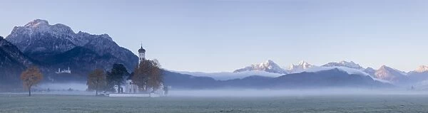 Panorama of St. Coloman Church surrounded by the autumn fog at sunrise, Schwangau
