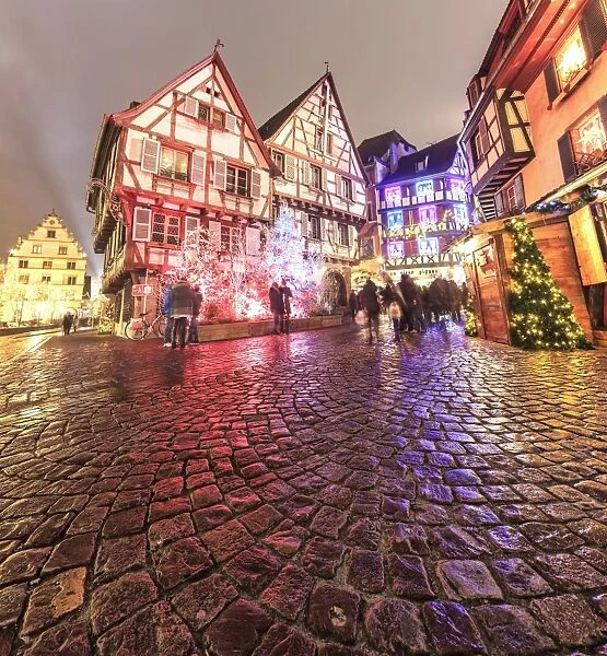 Panorama of typical houses enriched by Christmas ornaments and lights at dusk, Colmar