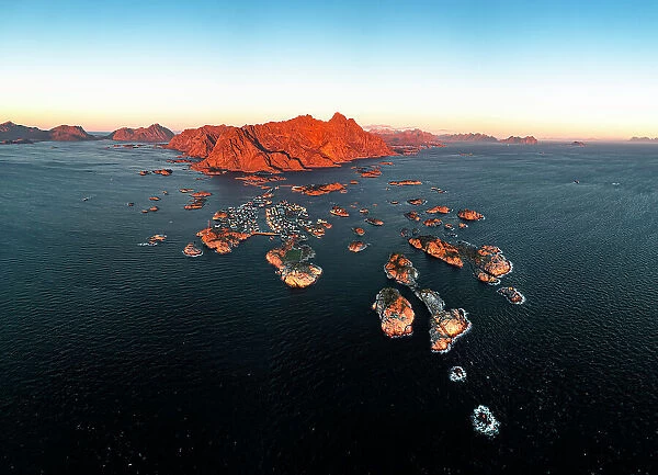 Panoramic aerial view of the fishing village of Henningsvaer and mountains at sunset, Nordland county, Lofoten Islands, Norway, Scandinavia, Europe
