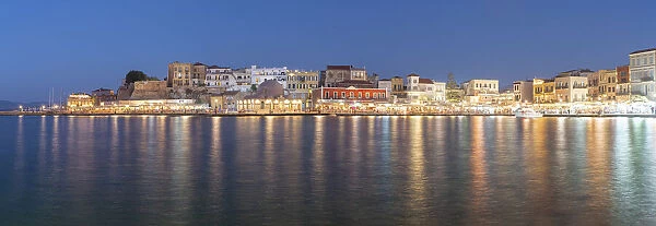 Panoramic of the illuminated old town and Venetian harbour of Chania at dusk, Crete