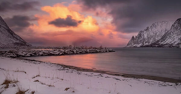 Panoramic image of Ersfjorden and The Devils Teeth viewed from Ersfjordstranda beach at sunset in winter, Senja, Troms og Finnmark County, Norway, Scandinavia, Europe