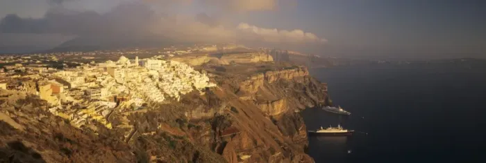 Framed Print : Panoramic image of Fira in the evening with cruiser and volcanic landscape, Santorini, Cyclades, Greek Islands, Greece, Europe Framed Print : Panoramic image of Fira in the evening with cruiser and volcanic landscape, Santorini, Cyclades, Greek Islands, Greece, Europe