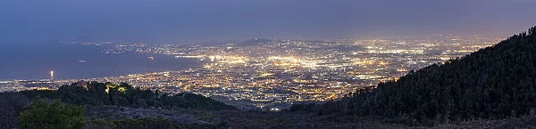 Panoramic of Naples city lights and Gulf at dusk from Vesuvius, Naples, Campania, Italy