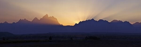 Panoramic photo of sunset over the Cathedral Group of mountains, Grand Teton National Park, Wyoming, United States of America, North America