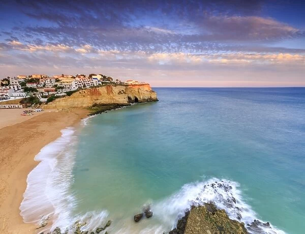 Panoramic view of Carvoeiro village surrounded by sandy beach and clear sea at sunset