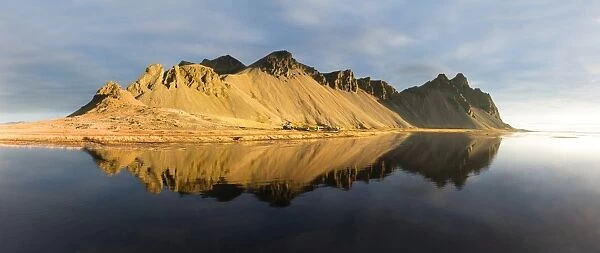 Panoramic view of mountains of Vestrahorn and perfect reflection in shallow water