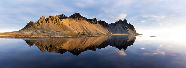 Panoramic view of mountains of Vestrahorn and perfect reflection in shallow water