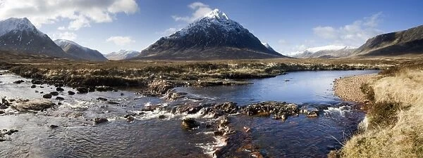 Panoramic view across River Etive towards snow-covered mountains including Buachaille Etive Mor