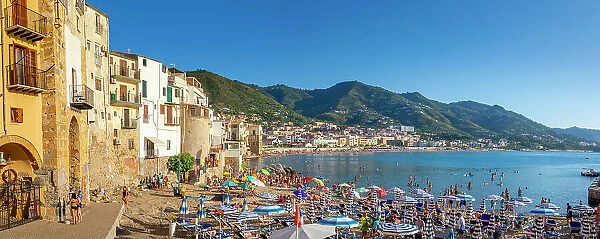 Panoramic view of tourists on beach, mountains in background, Cefalu, Province of Palermo, Sicily, Italy, Mediterranean, Europe