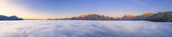 Panoramic view of Valmalenco at sunrise covered by a sea of clouds, Valtellina, Lombardy, Italy, Europe
