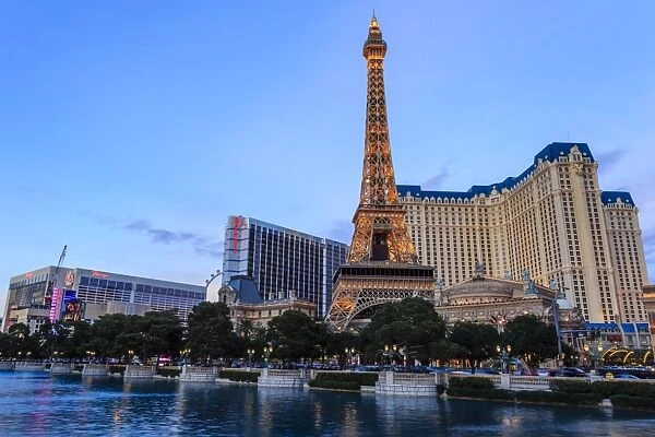 Paris, Ballys and Flamingo Hotels and High Roller Observation Wheel at dusk, viewed across Bellagio Lake, Las Vegas, Nevada, United States of America, North America