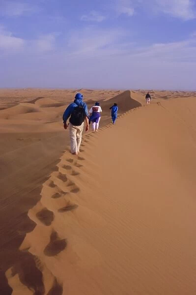 Party of trekkers on top of dunes at Chigaga