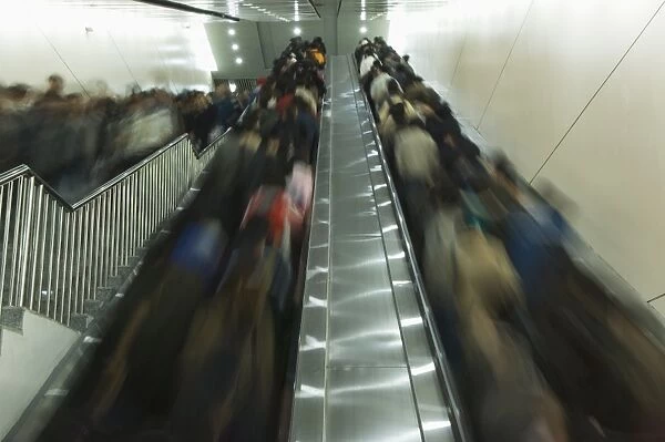 Passengers on moving escalators on the Beijing subway, Beijing, China, Asia