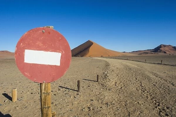No passing sign in front of the giant sand Dune 45, Sossusvlei, Namib-Naukluft National Park