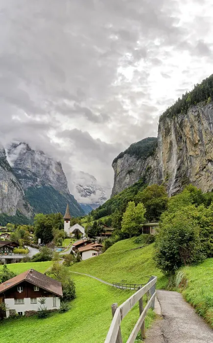 Framed Print : Path among green meadows of the alpine village of Lauterbrunnen with Trummelbach Falls in the background, Bern canton, Switzerland, Europe