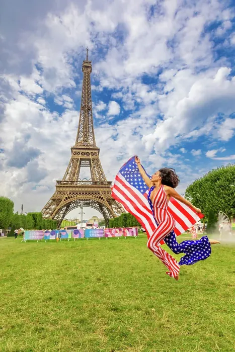 Framed Print : Patriotic American Woman jumping and cheering for Team USA and the Paris 2024 Olympics in front of the Eiffel Tower beach volleyball stadium, Paris, France, Europe