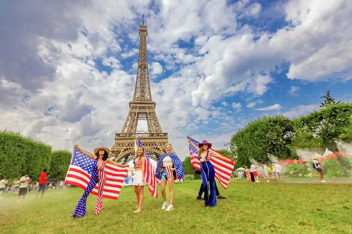Framed Print : Patriotic American Woman jumping and cheering for Team USA and the Paris 2024 Olympics in front of the Eiffel Tower beach volleyball stadium, Paris, France, Europe Framed Print : Patriotic American Woman jumping and cheering for Team USA and the Paris 2024 Olympics in front of the Eiffel Tower beach volleyball stadium, Paris, France, Europe