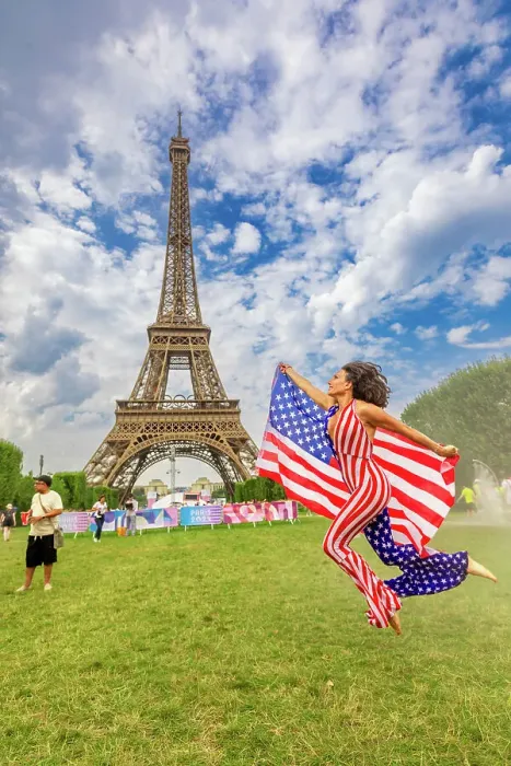 Framed Print : Patriotic American Woman jumping and cheering for Team USA and the Paris 2024 Olympics in front of the Eiffel Tower beach volleyball stadium, Paris, France, Europe Framed Print : Patriotic American Woman jumping and cheering for Team USA and the Paris 2024 Olympics in front of the Eiffel Tower beach volleyball stadium, Paris, France, Europe
