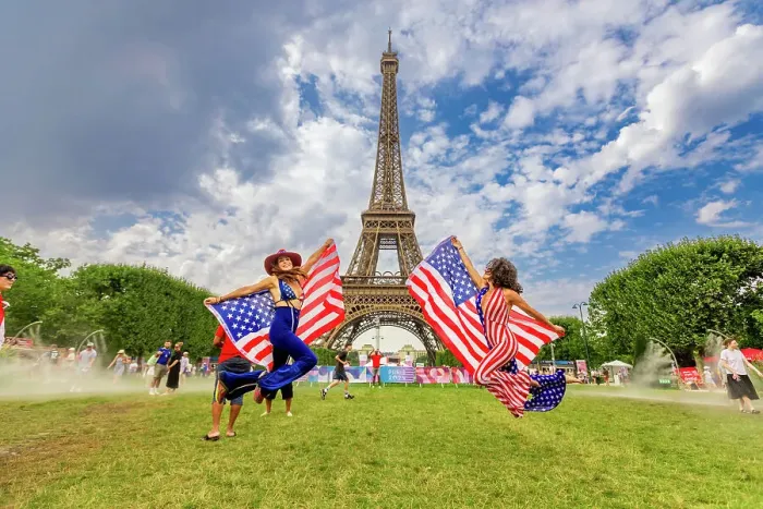 Framed Print : Patriotic American Woman jumping and cheering for Team USA and the Paris 2024 Olympics in front of the Eiffel Tower beach volleyball stadium, Paris, France, Europe Framed Print : Patriotic American Woman jumping and cheering for Team USA and the Paris 2024 Olympics in front of the Eiffel Tower beach volleyball stadium, Paris, France, Europe