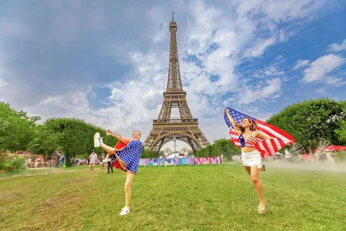 Framed Print : Patriotic American Woman jumping and cheering for Team USA and the Paris 2024 Olympics in front of the Eiffel Tower beach volleyball stadium, Paris, France, Europe Framed Print : Patriotic American Woman jumping and cheering for Team USA and the Paris 2024 Olympics in front of the Eiffel Tower beach volleyball stadium, Paris, France, Europe