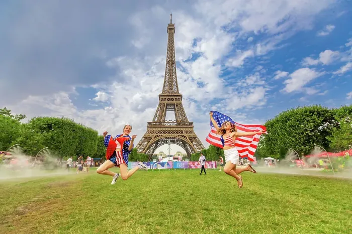 Framed Print : Patriotic American Woman jumping and cheering for Team USA and the Paris 2024 Olympics in front of the Eiffel Tower beach volleyball stadium, Paris, France, Europe Framed Print : Patriotic American Woman jumping and cheering for Team USA and the Paris 2024 Olympics in front of the Eiffel Tower beach volleyball stadium, Paris, France, Europe